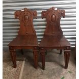 Pair of late Victorian oak hall chairs, raised on tapering square front supports and spade feet,