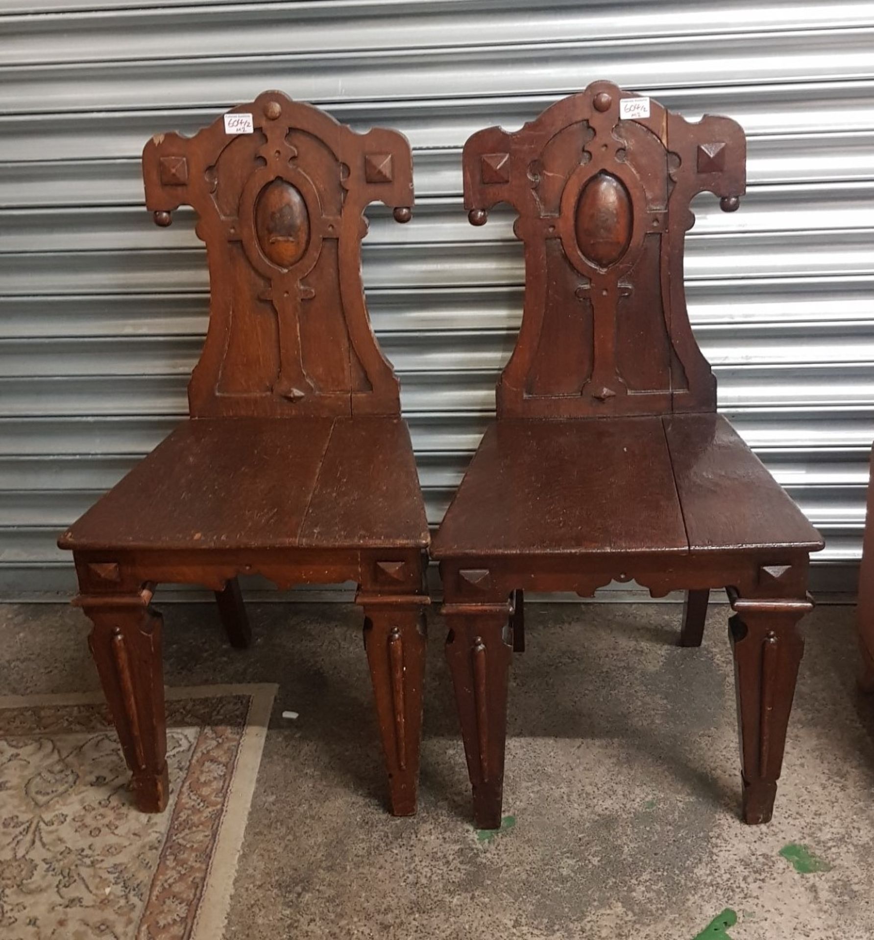 Pair of late Victorian oak hall chairs, raised on tapering square front supports and spade feet,