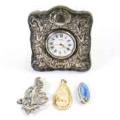 Pressed Silver cased clock, Silver Art Noveau style brooch and two other pendants. (4)