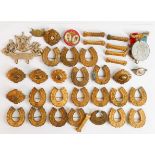 A collection of Queen Mary commemorative God Bless our Queen Horse shoe shaped badges