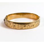 9ct gold ornate floral decorated bangle, 15.7g.