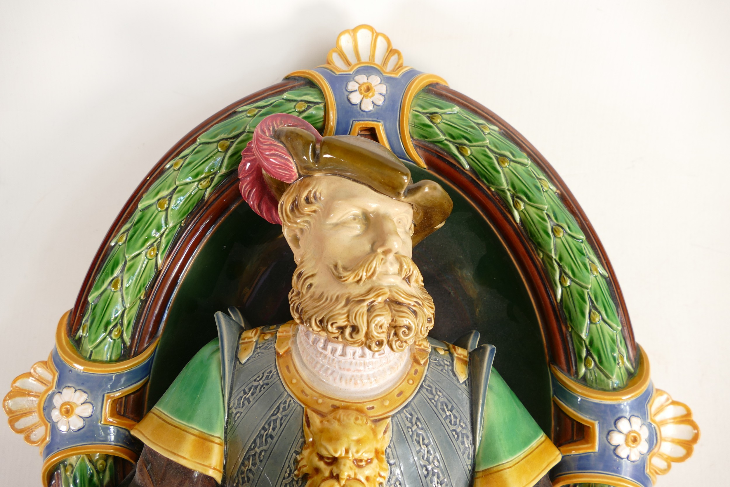 Minton Majolica wall sconce, in the form of a Renaissance man holding a torch, set in oval laurel - Image 2 of 3