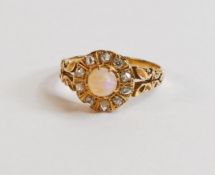 18ct gold ring set with central opal surrounded by 10 diamonds, 3.6g. Ring size R