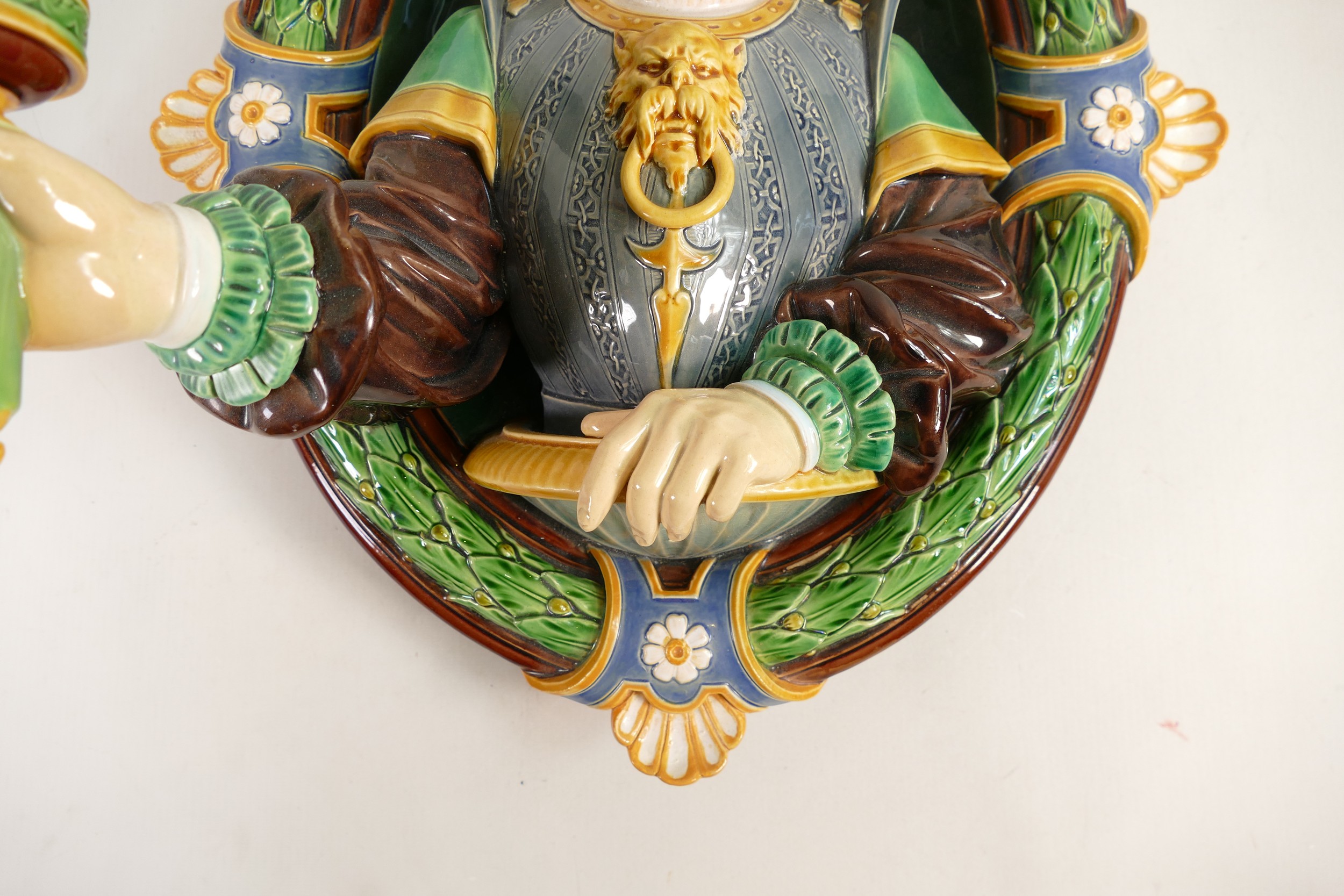 Minton Majolica wall sconce, in the form of a Renaissance man holding a torch, set in oval laurel - Image 3 of 3