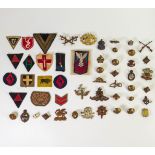 A collection of WWII & later Military cap badges, button & patches including South Wales Borders,