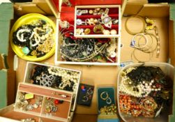 A large collection of costume jewellery including beads, brooches, chains, pendants, brooches,