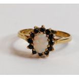 9ct gold ladies dress ring, set with opal and black stones, size N, 1.9g.