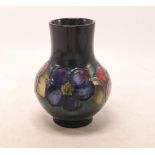 Walter Moorcroft vase in the clematis design, h.12.5cm, restored top rim.