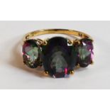 9ct gold ladies dress ring, set with three purple stones, size O, 3.3g.