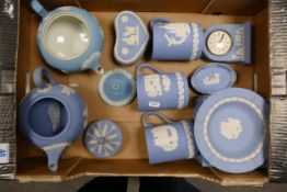 A collection of Wedgwood Blue Jasper Ware to include Teapot, Mantle Clock, Tankards, lidded