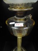 Early 20th Century Glass and Brass Oil Lamp in Collum form. Overall Height Includung Chimney 74cm