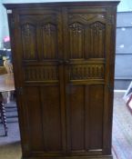 Dark oak Gentleman's wardrobe with hanging rail and shelves to the interior, Lock of London branded,