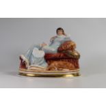 Arena Staffordshire china figurine of a lady seated on a couch. Marked specialy painted for K Taylor