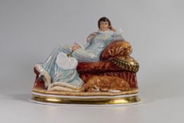 Arena Staffordshire china figurine of a lady seated on a couch. Marked specialy painted for K Taylor
