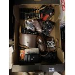 A collection of vintage cameras to include Kodak and Practika examples, cased pair of binoculas