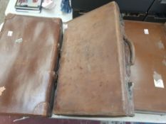 Three pieces of vintage luggage to include 1 leather case initialled GBT, largest 66cm x 40cm, one