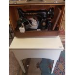 A cased electric Singer sewing machine, serial number EJ425762, together with a purpose made