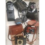 A collection of vintage camera equipment to include Pentax, Olympus and Kodak examples, plus