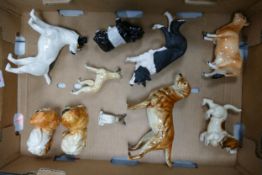 A collection of Goebel & similar pottery dog figures including Jack Russell, Pekingese, Labrador,