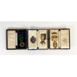 Two cased hallmarked silver masonic medals, an unidentifield cased silver medal and an additional