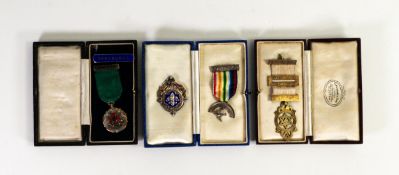 Two cased hallmarked silver masonic medals, an unidentifield cased silver medal and an additional