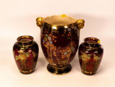 A pair of Crown Devon rouge royalle vases in the butterfly design together with a larger vase with