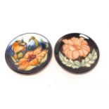 Two Moorcroft plates in a orange floral design. Diameter 16cm, dated 1998 and 1996 (2)