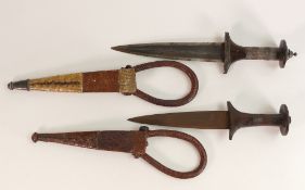 Two Sudanese Arm Daggers. One example with silver braided handle, snakeskin and camel leather sheath