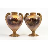 Pair of twin handled vases decorated with Highland cattle, signed G Cox. Height 21cm. One has