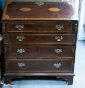 19th century Mahogany crossed banded and shell inlaid bureau with brass handles and bracket feet.