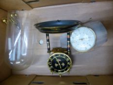 A Metamec mantle clock together with a West German anniversary type clock with glass dome.