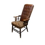 19th century upholstered armchair on turned legs and arm supports, high buttoned leather back