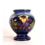 Moorcroft Columbine vase on a faded blue background. Potters to the late Queen Mary sticker to base,