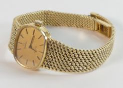 18ct gold ladies larger size Omega De Ville wrist watch and integral 18ct gold bracelet stamped 750.