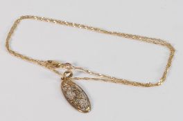 9ct gold pendant and chain, the oval shaped pendant with flower design set with tiny diamonds (one