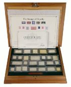 The stamps of Royalty - 25 x sterling silver iconic UK stamps, in original inlaid wooden case of