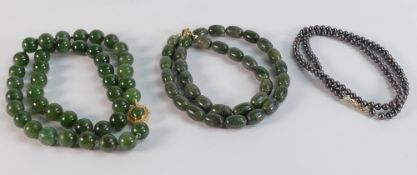 Spinach Jade (or similar) beads with 14k gold clasp 52cm, 10mm beads appx., together with a