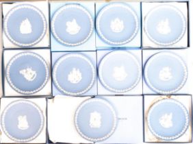 A collection of boxed Wedgwood Jasperware Christmas & year plates, diameter 22cm (11)