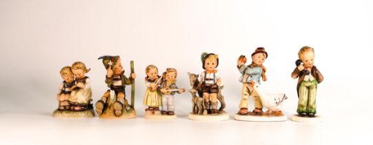 A collection of Goebel Hummel figures including Smart Little Sister, Mountaineer Hiking Boy, Goat