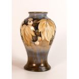 William Moorcroft salt glazed vase decorated in the Leaf & Berry design, c1940s, h.15cm.