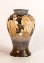 William Moorcroft salt glazed vase decorated in the Leaf & Berry design, c1940s, h.15cm.
