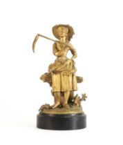 19th century gilt-bronze figure of a Harvester, scythe in hand with distressed fence and farming