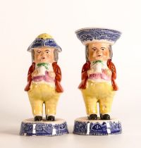 A pair of Staffordshire Toby cruet figures - including one salt cellar and a sifter / muffineer with