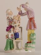 Meissen 20th century Oriental family group. Mother steadying her child on a chair, father stood