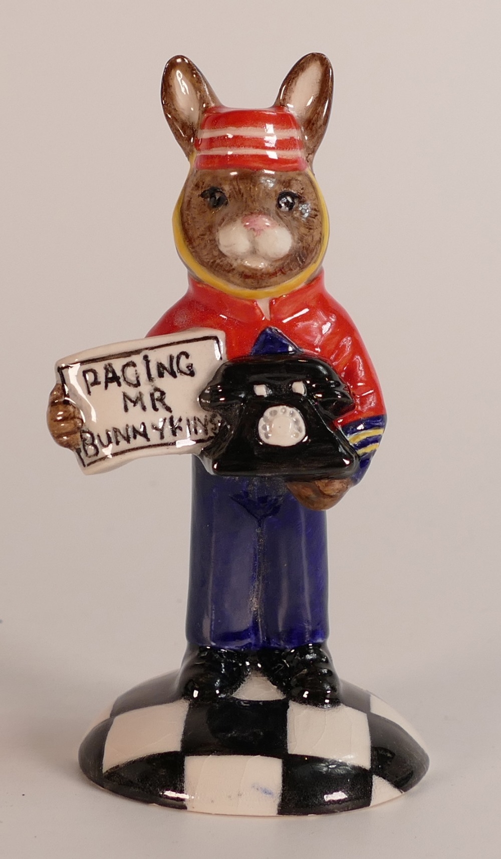 A Royal Doulton prototype Bunnykins figure of a Hotel Bell Boy holding a telephone and a sign that