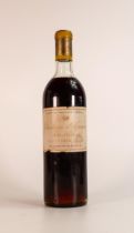 A bottle of 1959 red wine "Château D'Yquem, Lur Saluces". Label has tears & soiled, wine 3.5cm below