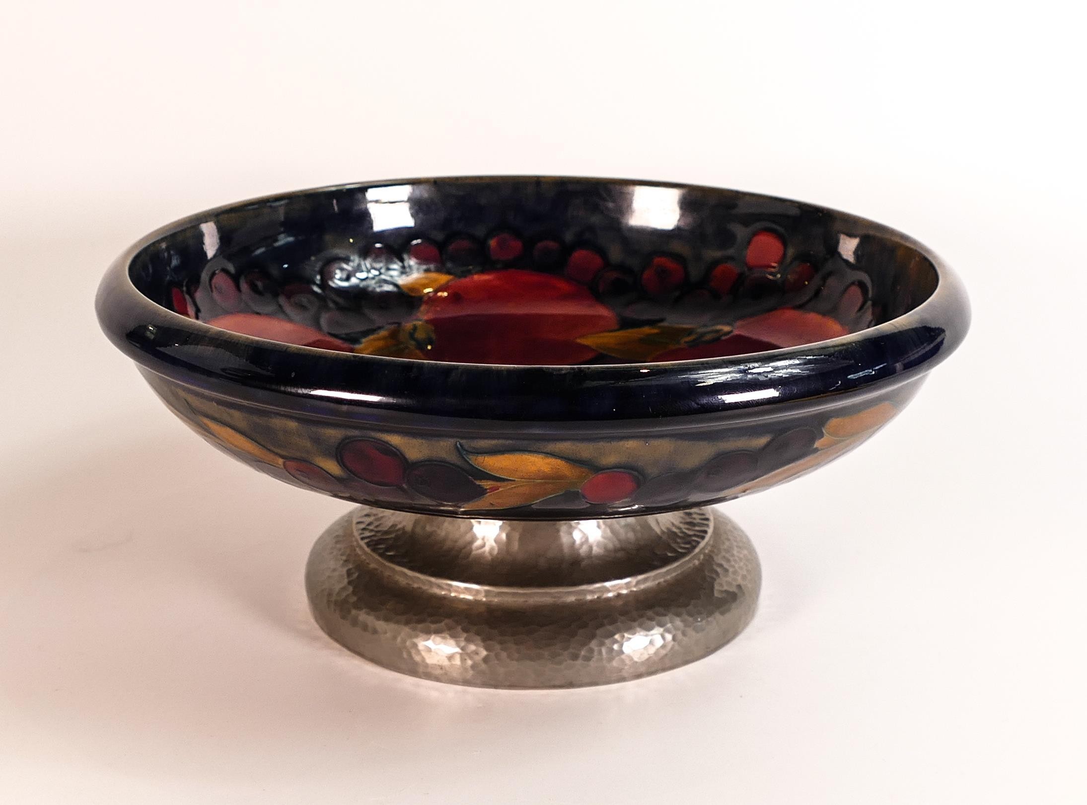 William Moorcroft large footed fruit bowl decorated in the Pomegranate design, Tudric Pewter base,