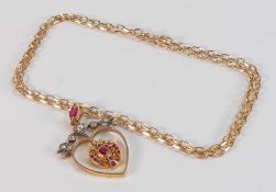 An Indian design pendant & chain, formed as a heart with bird set with rough cut rubies, old cut
