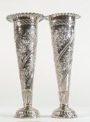 Pair of silver vases, ornately decorated with flowers, hallmarked for London 1892, h.16cm, bases