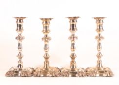 Set of four Rococo decorated silver candlesticks, all by the same maker, Henry Wilkinson & Co.